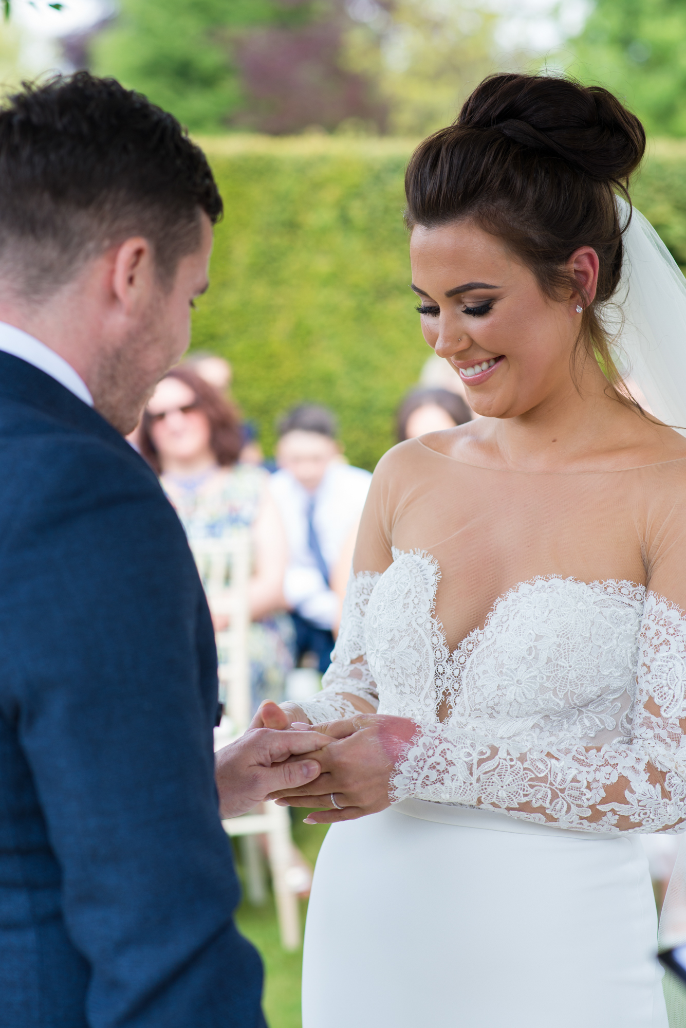A bride and groom exchanging rings at Chippenham park wedding venue